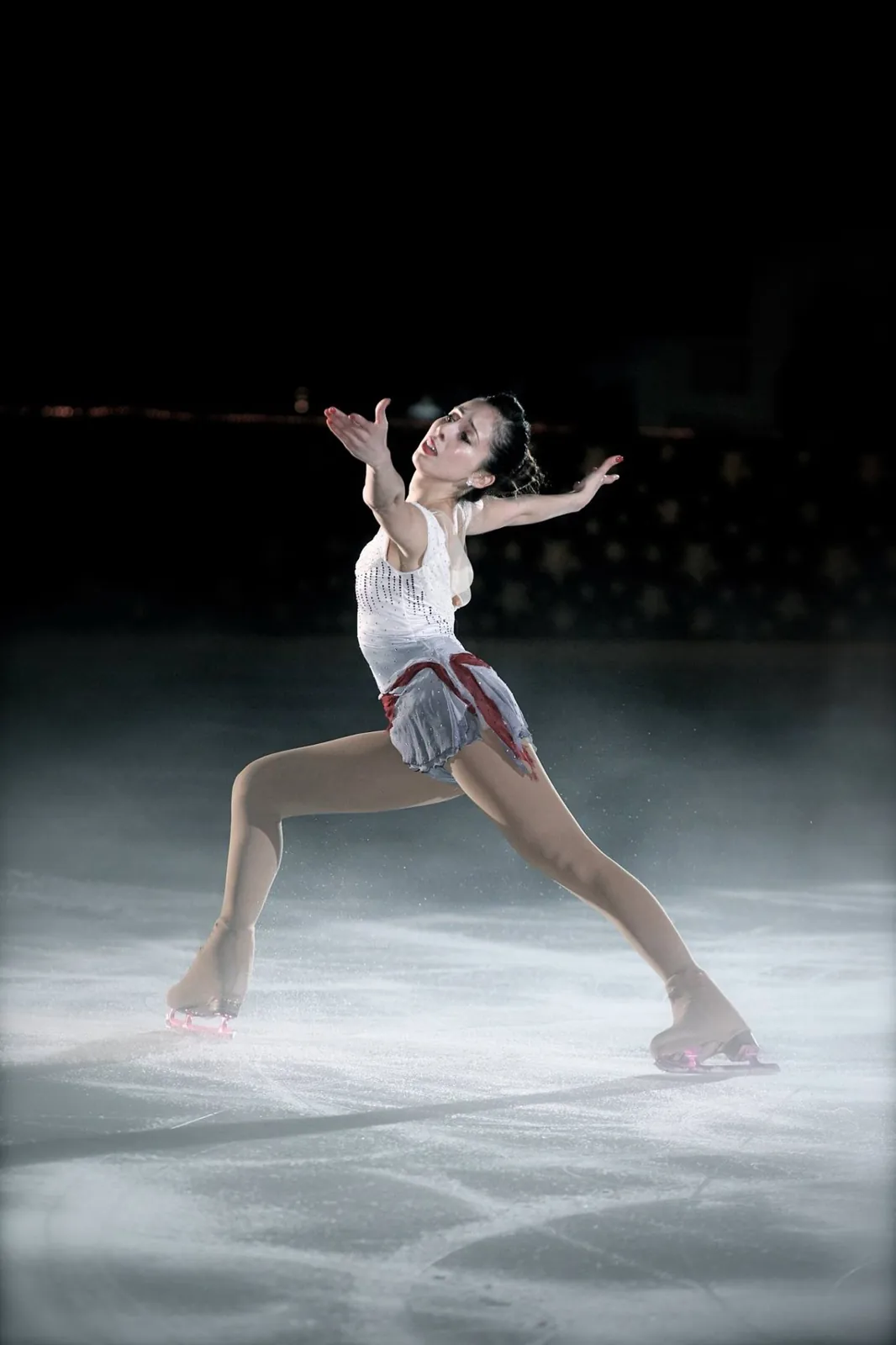 Crystalrose performing an expressive figure skating routine under the spotlight